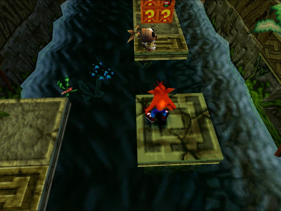 Crash advances on stone slabs between crates in a jungle level of Crash Bandicoot 2