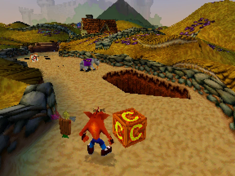Crash crashes on a sandy path near a C crate in Crash Bandicoot 3: Warped