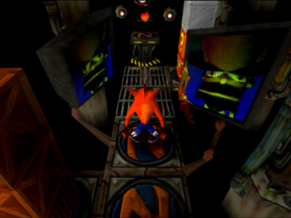 Crash advances between the giant machines in a dark level of Crash Bandicoot on PlayStation